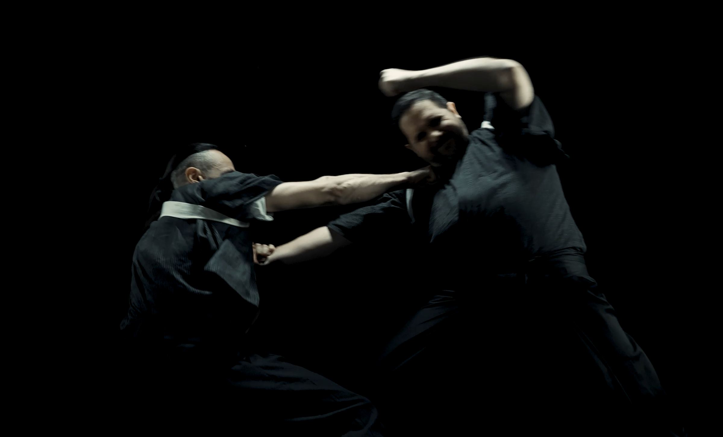 Two ninjutsu practitioners training a strike during a class in Barcelona
